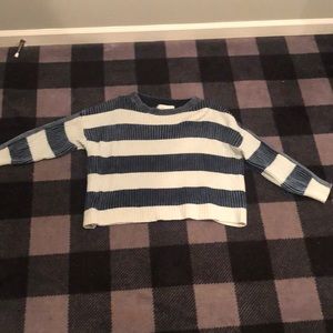 An oversized knitted dark blue and black sweater